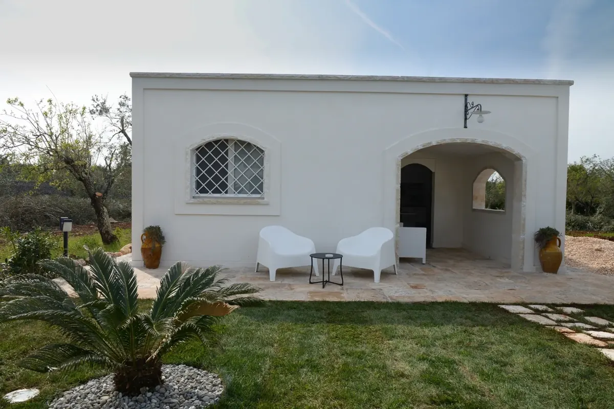 La Dependance di Trullux, con l'arco in pietra e il giardino