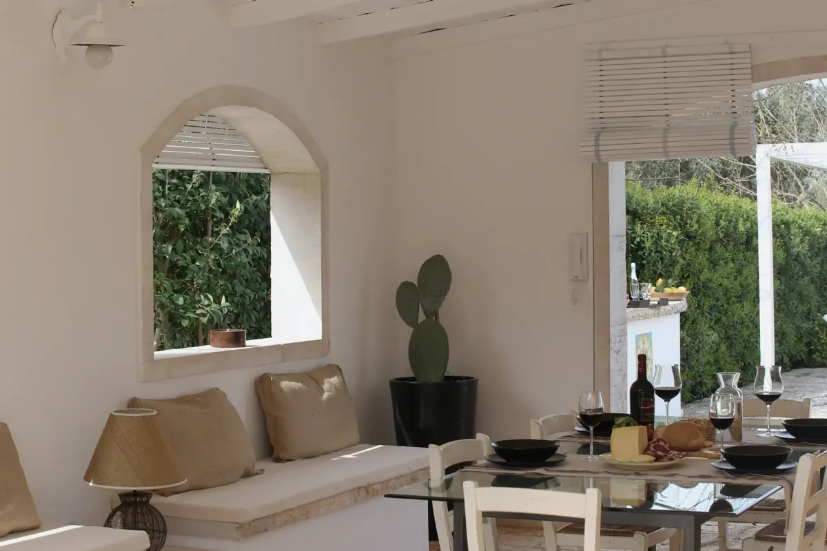 The veranda with the arched window and the table set